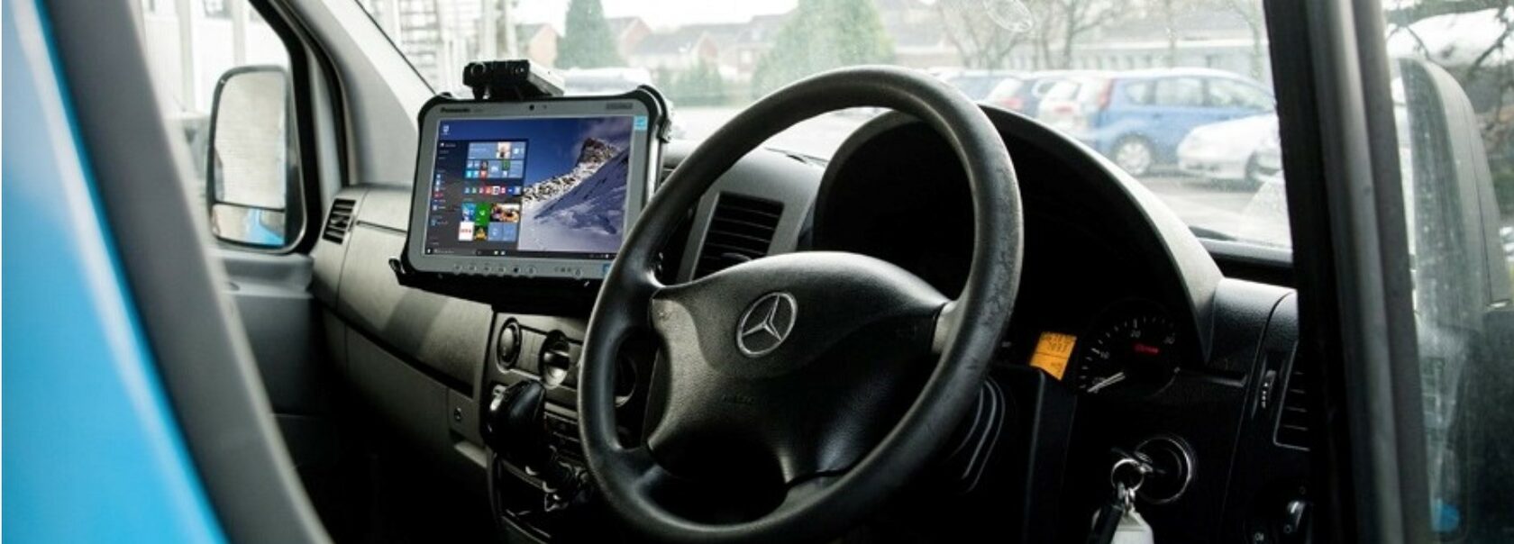 TOUGHBOOK G1 mounted in G1 slim dock onto the dashboard of a vehicle