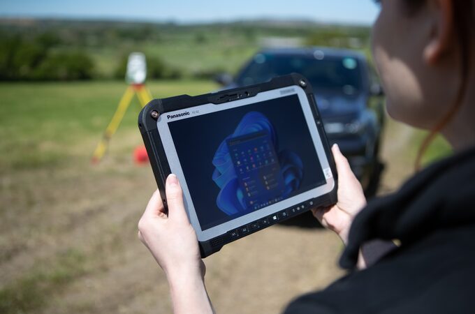 woman with device in hand for field survey